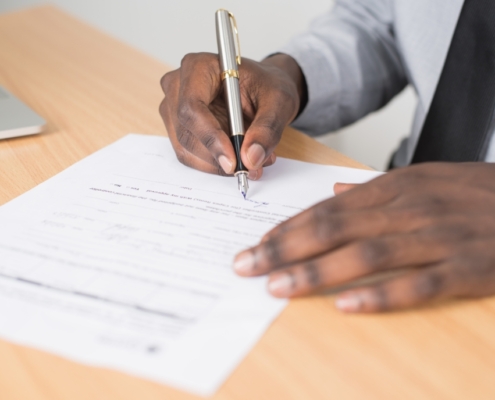 Man signing a form