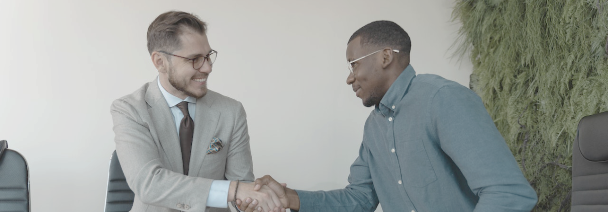 Two men shaking hands following a job interview.